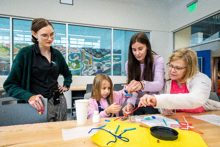 Families making art together at a hands-on workshop