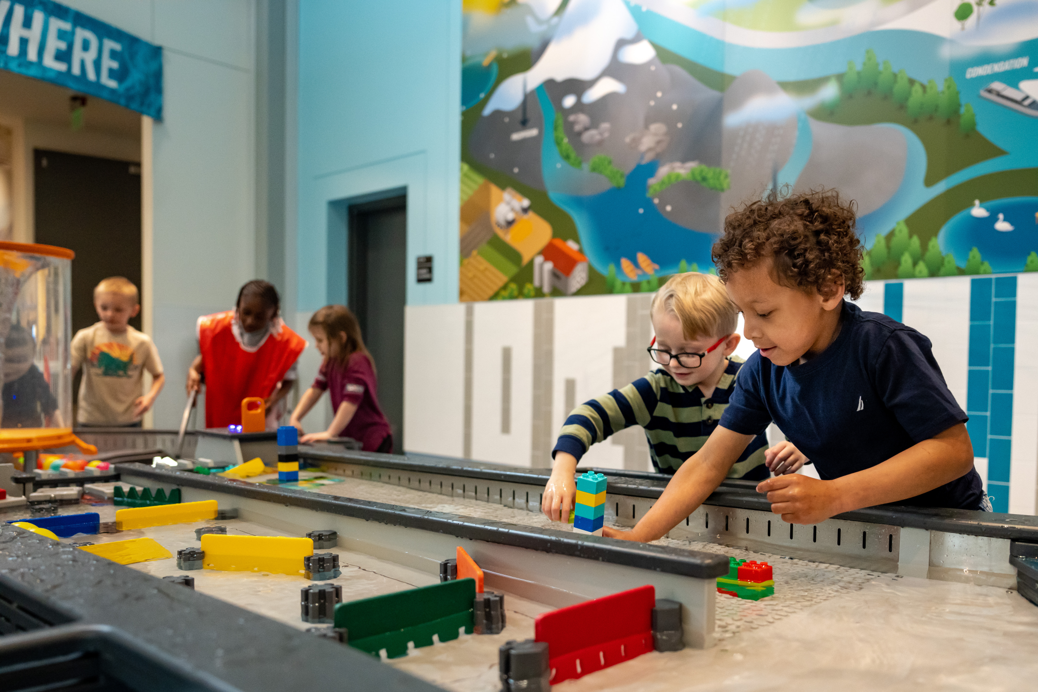 Children exploring a hands-on exhibit at the Sloan Museum of Discovery